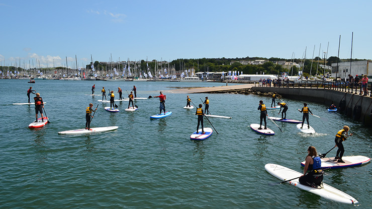 People using paddle boards on the water at Plymouth