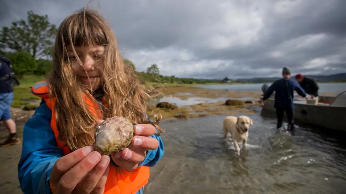 Young girl holding an oyster