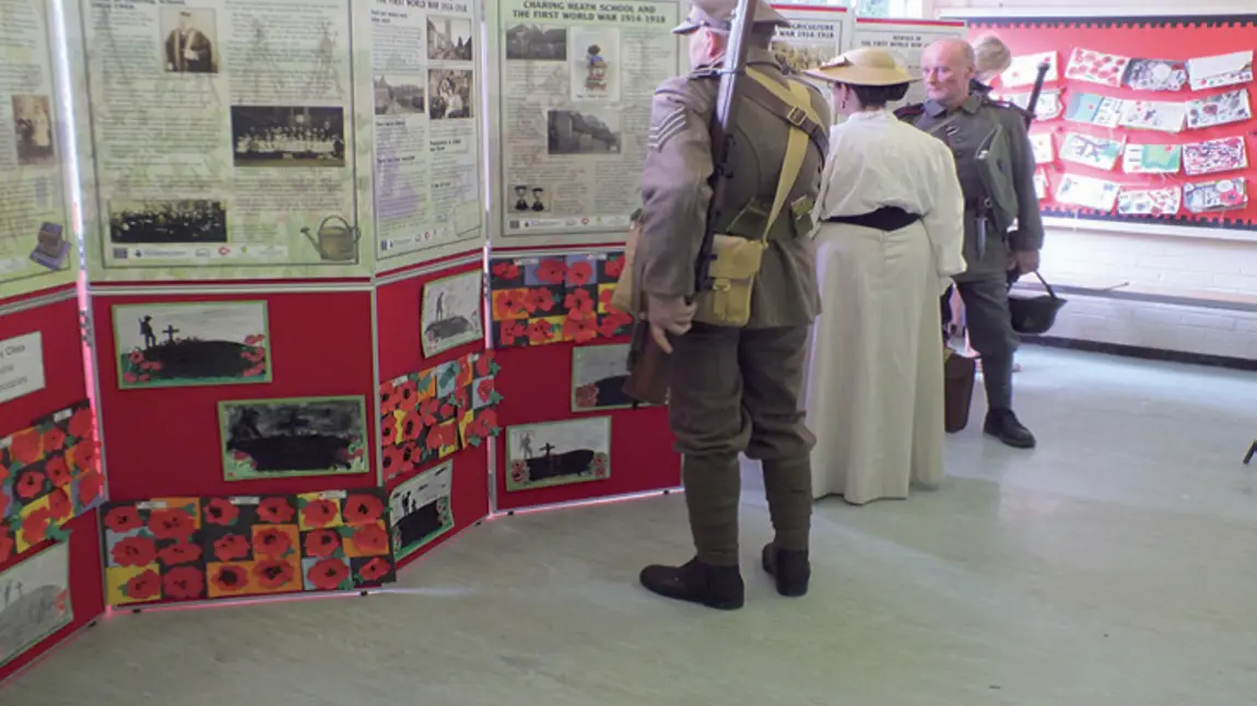Re-enactors from the WW1 Remembrance Centre, Portsmouth looking at school panels, plus children’s own work