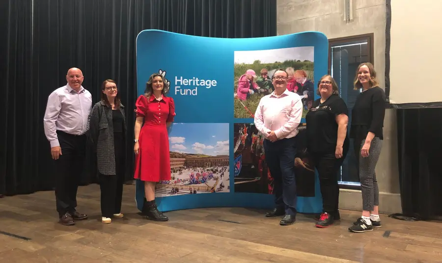 The North management team standing in front of a Heritage Fund branded banner