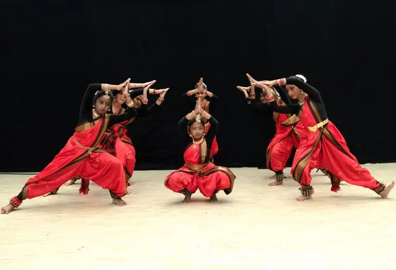 A group of young people perform an Indian classical dance called Bharatanatyam.