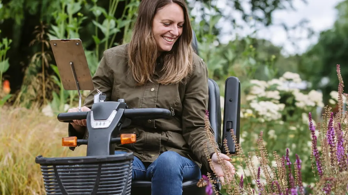 3)	A visitor using a mobility scooter in the Wellbeing Garden at RHS Garden Wisley