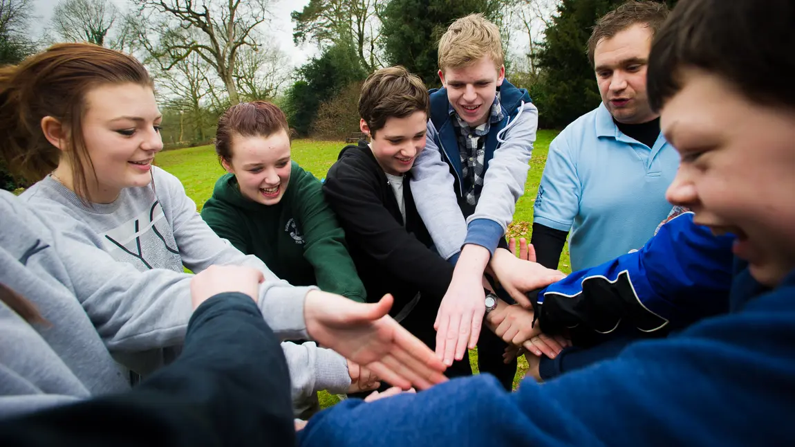 Young people teambuilding in a park