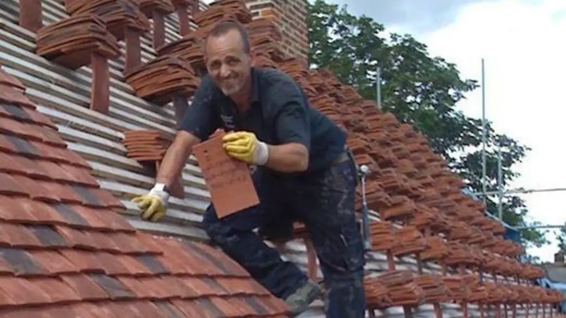 A man retiling the roof at Finchingfield